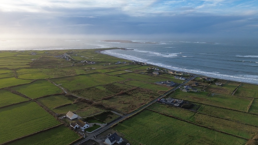 An aerial view of Seafield Pier and Mutton Island on the coast of County Clare, Ireland.